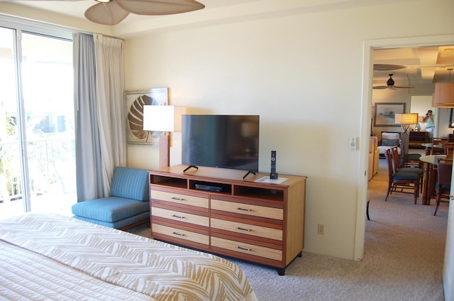 carpeted bedroom featuring ceiling fan and access to exterior