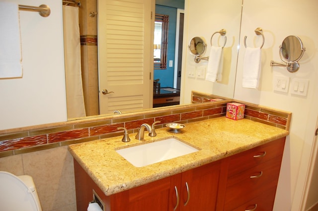 bathroom with toilet and vanity