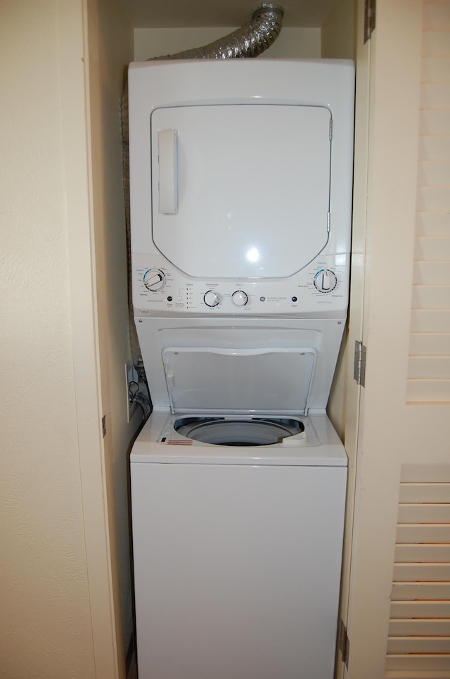 laundry area featuring stacked washing maching and dryer