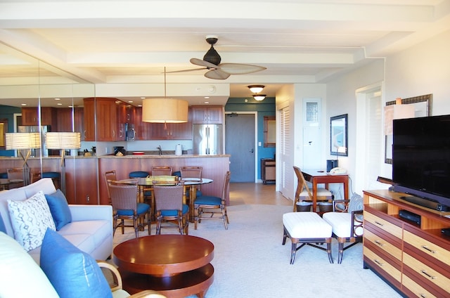 living room with ceiling fan, sink, and beamed ceiling