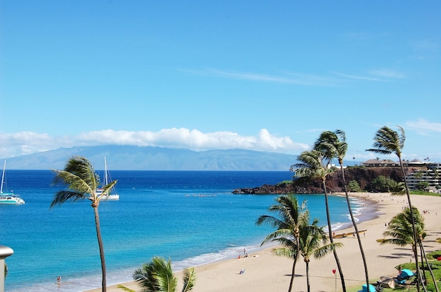 water view with a mountain view and a view of the beach