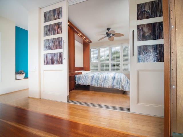 unfurnished bedroom with ceiling fan and wood-type flooring