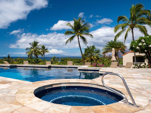 view of pool with a patio area and an in ground hot tub