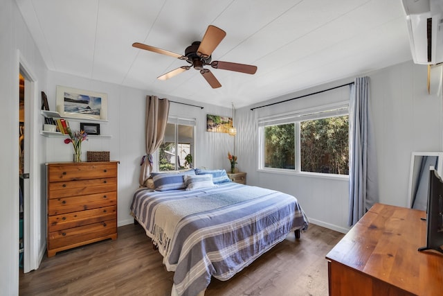 5131 Hanawai St Unit F, Lahaina, HI 96761 - bedroom with wood finished floors, a wall mounted air conditioner, a ceiling fan, and baseboards