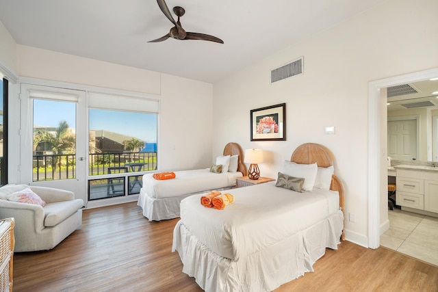 bedroom with ensuite bath, ceiling fan, and light wood-type flooring