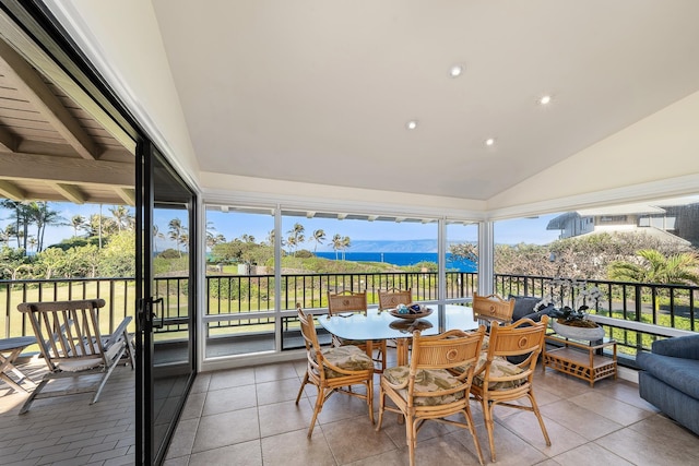 sunroom / solarium with a mountain view, a wealth of natural light, and lofted ceiling