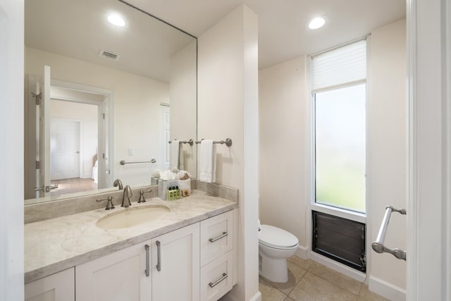 bathroom featuring tile patterned flooring, vanity, and toilet