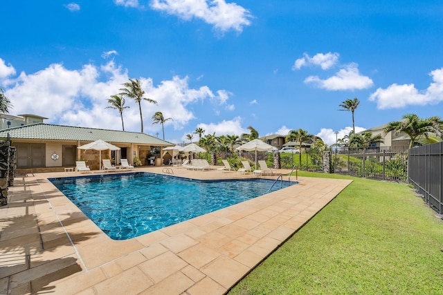 view of swimming pool featuring a yard and a patio