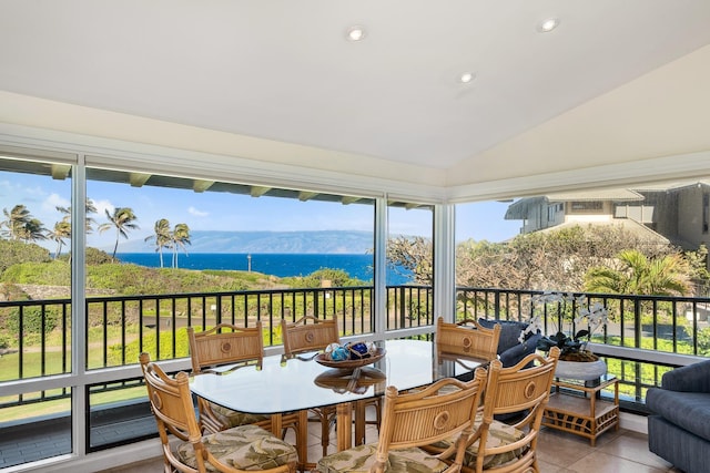 sunroom with vaulted ceiling and a water and mountain view