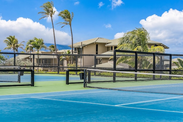 view of tennis court featuring basketball hoop