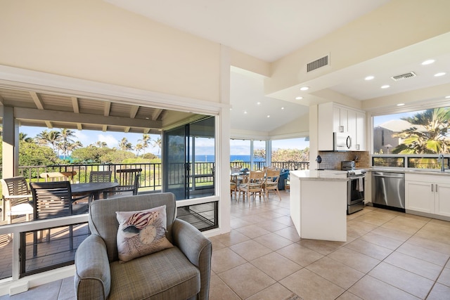 kitchen featuring sink, light tile patterned floors, appliances with stainless steel finishes, tasteful backsplash, and white cabinetry