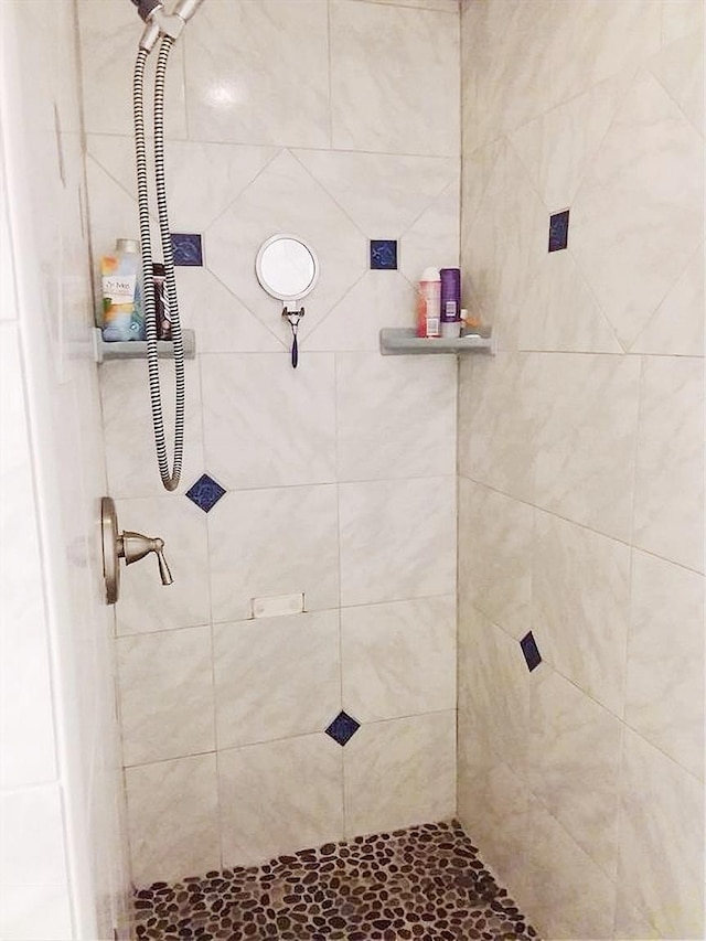 full bath with a tile shower