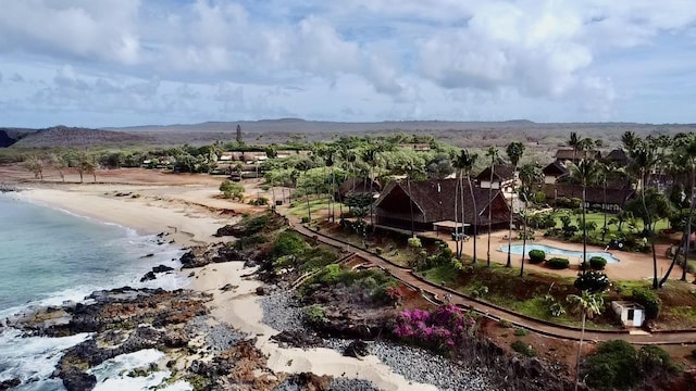 drone / aerial view featuring a water view and a beach view