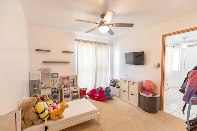 rec room featuring ceiling fan and light colored carpet