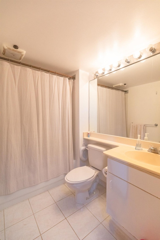 full bathroom with shower / bath combo with shower curtain, toilet, vanity, and tile patterned flooring