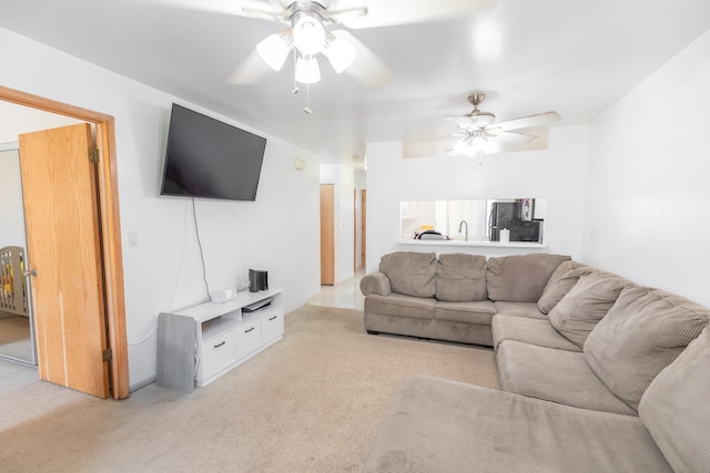 living room featuring ceiling fan and light carpet