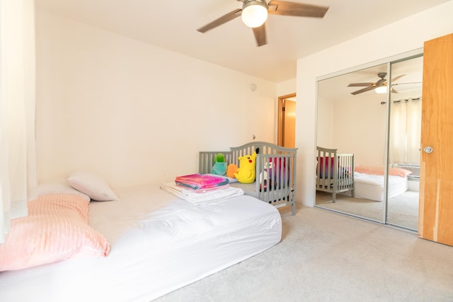 carpeted bedroom with a closet and ceiling fan