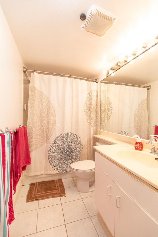 bathroom featuring toilet, tile patterned flooring, and vanity