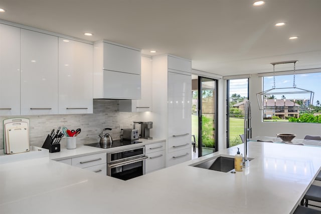 3300 Wailea Alanui Dr Unit 32A, Kihei, HI 96753 - kitchen featuring stainless steel oven, modern cabinets, black electric cooktop, a sink, and recessed lighting