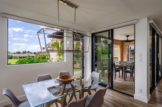 3300 Wailea Alanui Dr Unit 32A, Kihei, HI 96753 - dining room featuring healthy amount of natural light, wood finished floors, a chandelier, and baseboards