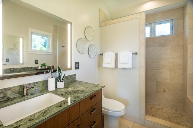 full bath featuring vanity, toilet, tile patterned floors, and walk in shower