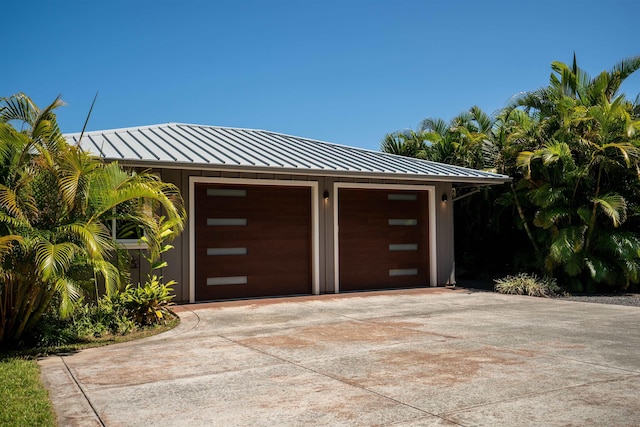 garage featuring concrete driveway