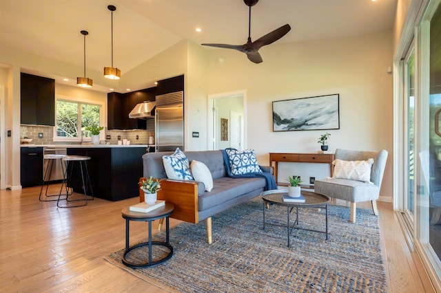 living room featuring light wood finished floors, high vaulted ceiling, recessed lighting, and a ceiling fan