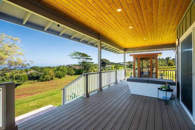 wooden deck featuring a lawn