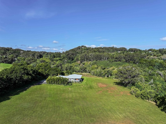 birds eye view of property with a wooded view