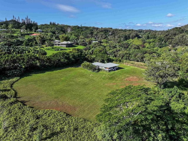 birds eye view of property with a view of trees