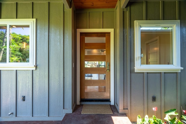 view of exterior entry featuring board and batten siding