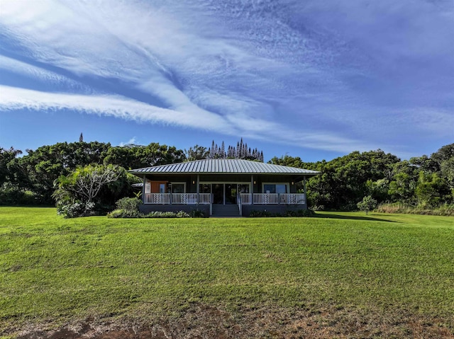 view of front facade featuring a porch, a front lawn, and metal roof