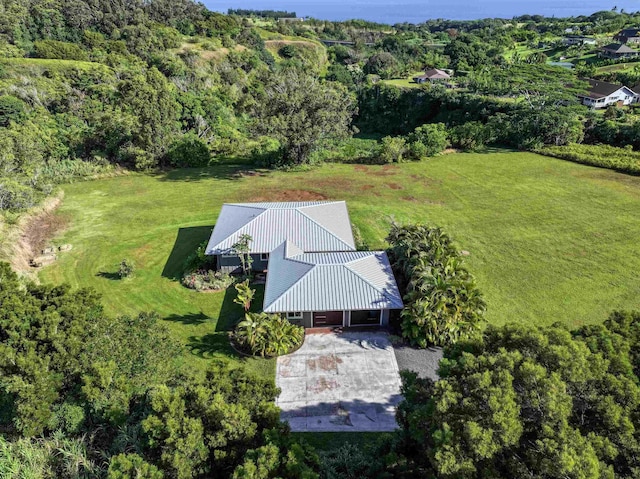 drone / aerial view with a wooded view