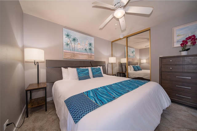 tiled bedroom featuring ceiling fan and a closet