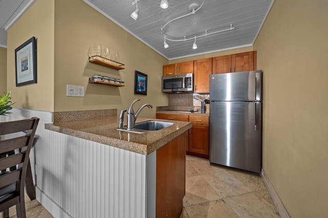 kitchen with crown molding, stainless steel appliances, kitchen peninsula, sink, and track lighting