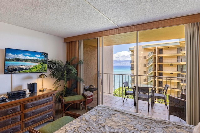 4365 Lower Honoapiilani Rd Unit 603, Lahaina, HI 96761 - bedroom featuring tile patterned floors, access to outside, a textured ceiling, and a water view