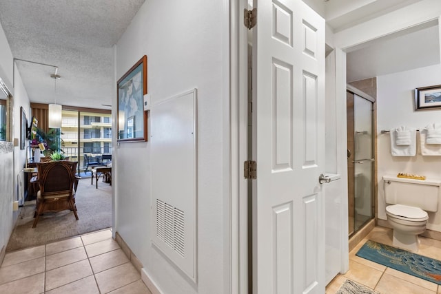 4365 Lower Honoapiilani Rd Unit 603, Lahaina, HI 96761 - hallway featuring light tile patterned floors and a textured ceiling