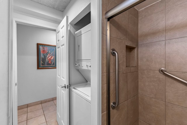 4365 Lower Honoapiilani Rd Unit 603, Lahaina, HI 96761 - laundry area featuring estacked washer and dryer and light tile patterned flooring