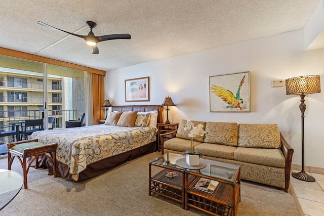 4365 Lower Honoapiilani Rd Unit 603, Lahaina, HI 96761 - tiled bedroom featuring a textured ceiling, ceiling fan, and a wall of windows