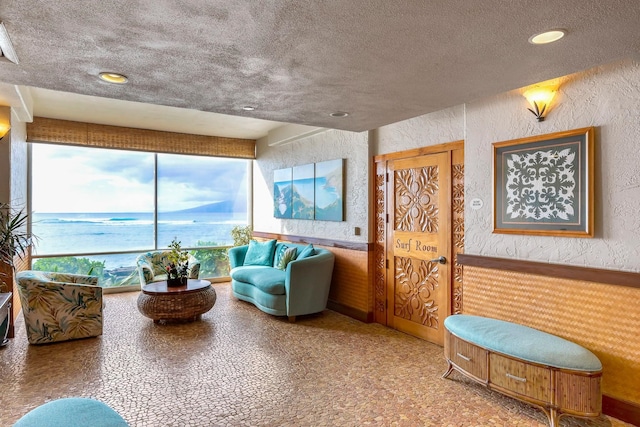 4365 Lower Honoapiilani Rd Unit 603, Lahaina, HI 96761 - living area featuring a textured wall, a textured ceiling, recessed lighting, and a water view