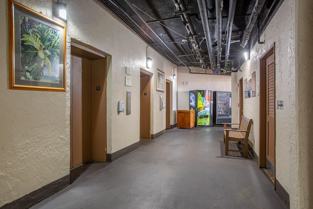 4365 Lower Honoapiilani Rd Unit 603, Lahaina, HI 96761 - hall featuring a textured wall, concrete flooring, elevator, and baseboards