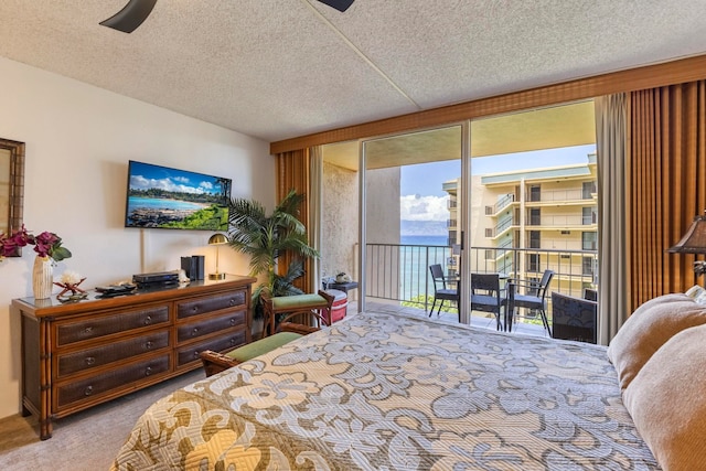 4365 Lower Honoapiilani Rd Unit 603, Lahaina, HI 96761 - carpeted bedroom featuring access to exterior, expansive windows, a textured ceiling, and a ceiling fan