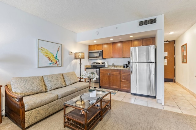 4365 Lower Honoapiilani Rd Unit 603, Lahaina, HI 96761 - living room featuring light tile patterned floors and a textured ceiling