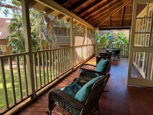 sunroom / solarium with plenty of natural light, lofted ceiling, and wood ceiling