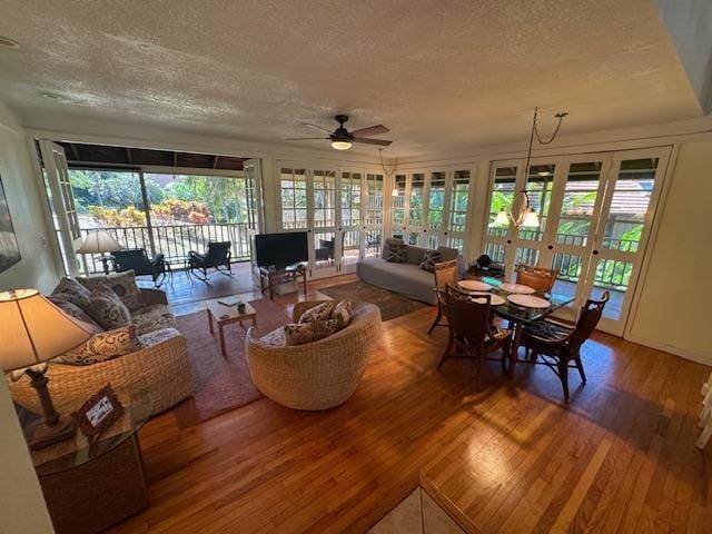 sunroom with plenty of natural light, ceiling fan, and french doors