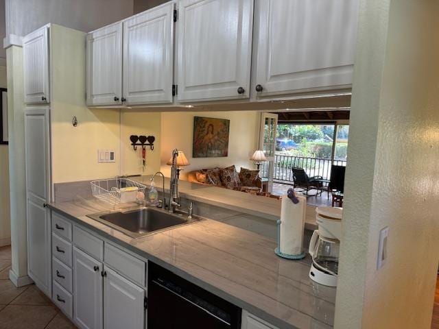 kitchen featuring sink, white cabinets, dishwasher, and light tile patterned floors