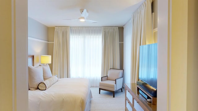 bedroom with ceiling fan and light carpet