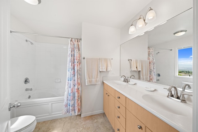 bathroom with shower / bath combo, toilet, double vanity, and baseboards