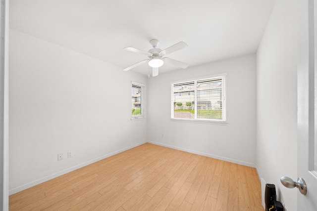 empty room with baseboards, light wood-style floors, and a ceiling fan
