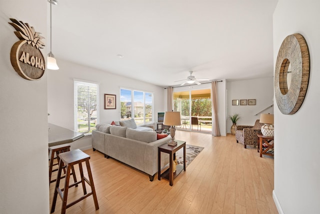 living room with ceiling fan and light wood-style floors